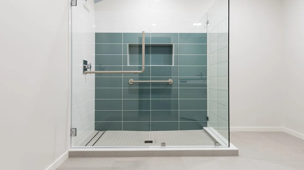 Level-access tiled shower with a low-profile tray and a wall-mounted grab rail in a renovated Tauranga bathroom