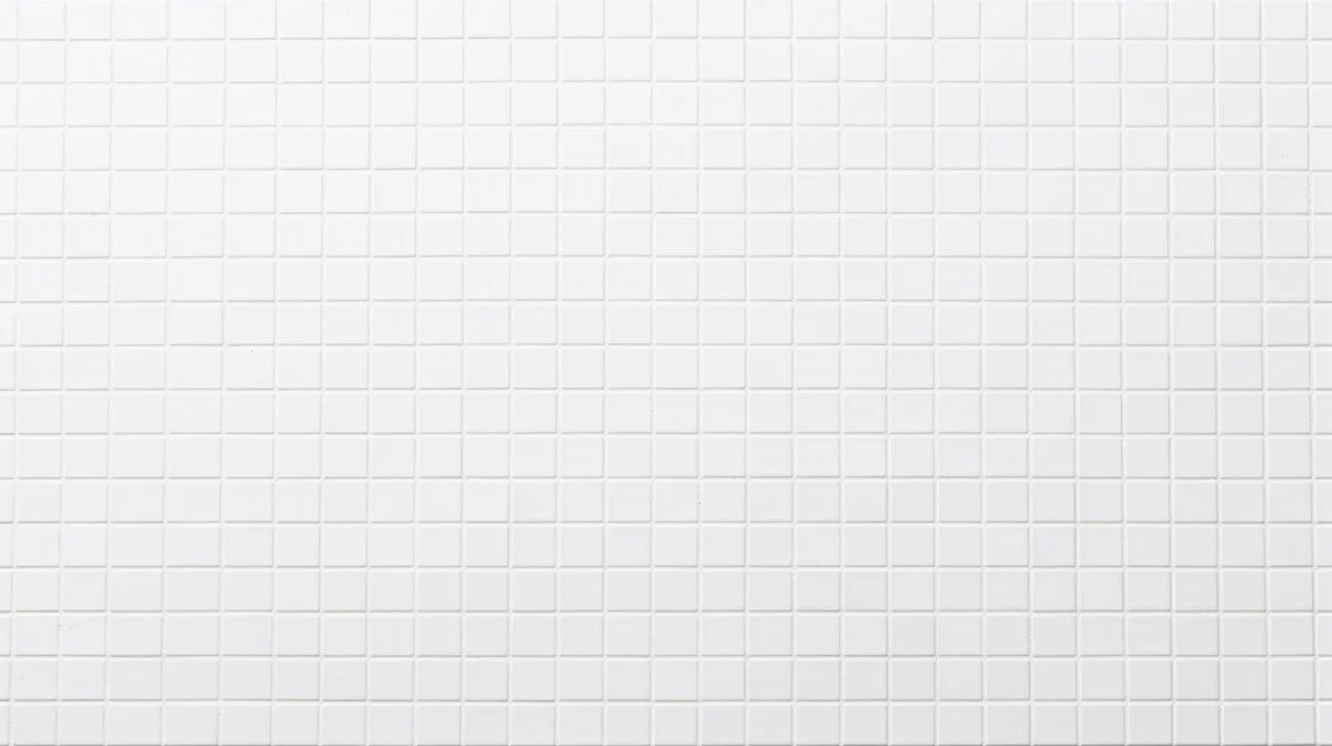 A neat grid of plain white ceramic tiles on a bright white surface