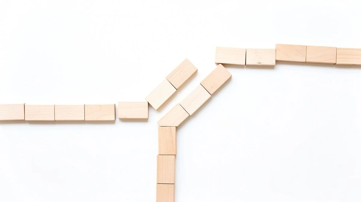 Plain wooden blocks arranged as two diverging paths on a white surface