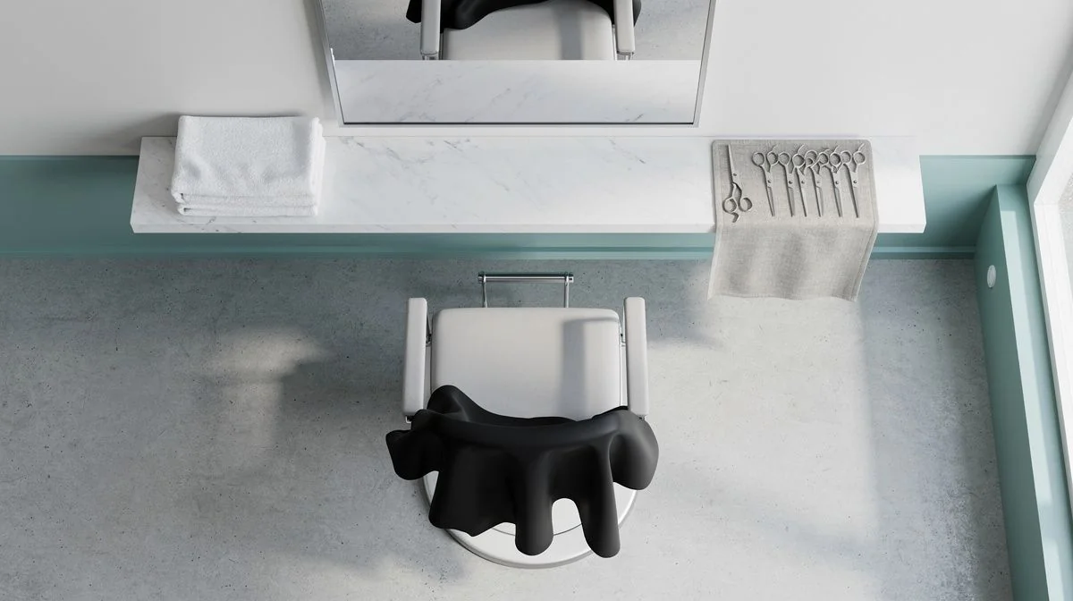 Empty salon chair, mirror, folded towels and scissors on a bench