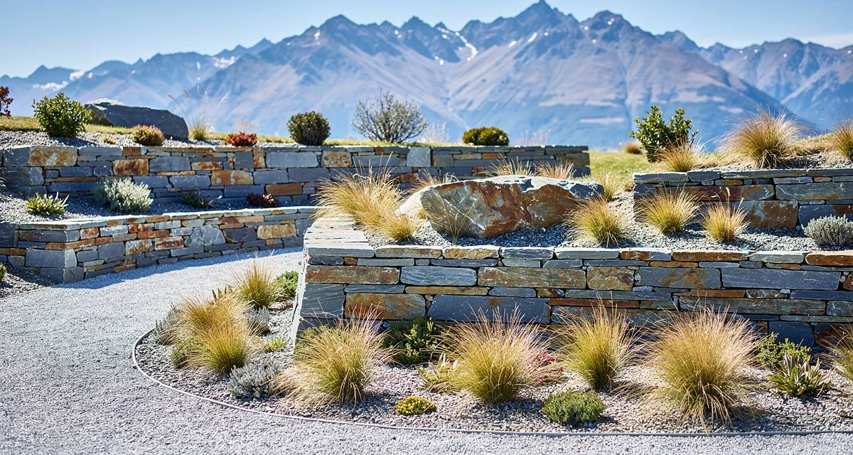 Schist stone wall and tussock planting in a newly completed Queenstown garden