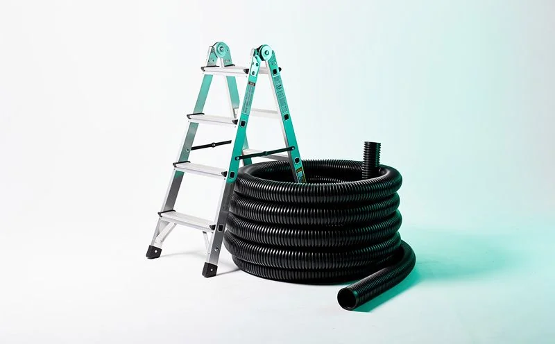 A short section of aluminium ladder beside a coil of black plastic downpipe